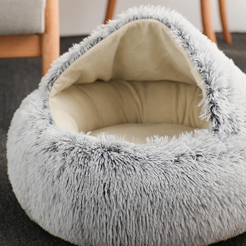 Cat comfortably resting in a Calming Pet Nest, the ultimate comfort bed for cats and dogs, featuring plush faux fur and high walls for added security