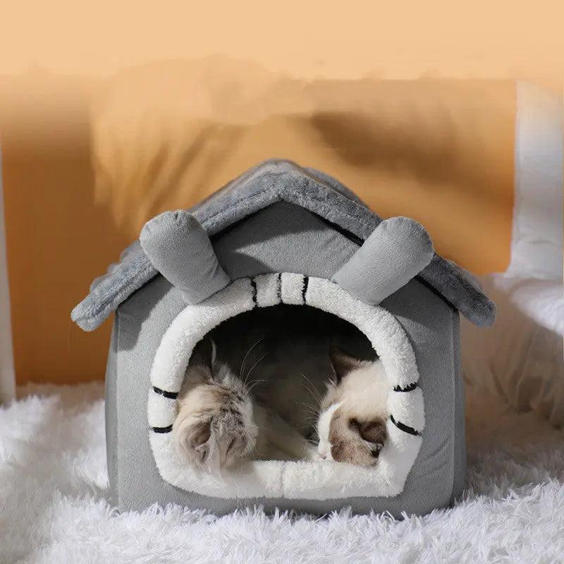 Gray plush cat house with soft white interior, featuring a cottage design and roof ears, perfect for cozy cat naps.