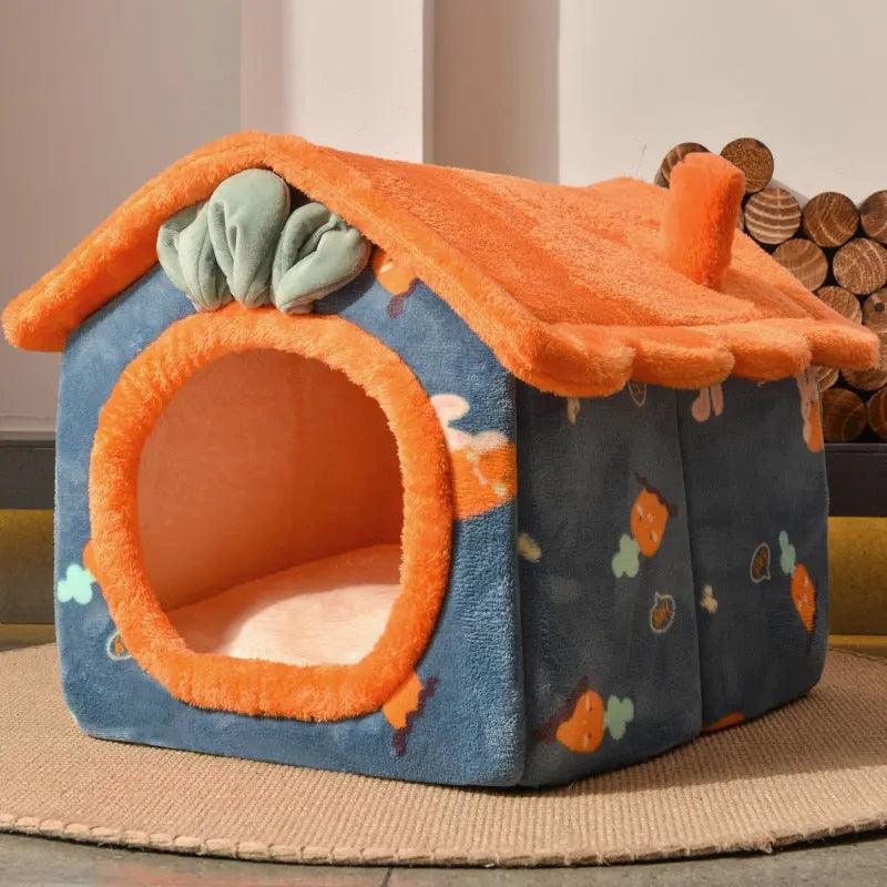 Colorful plush cat house with vibrant orange roof and cozy blue walls, featuring playful patterns, perfect for cats to rest and play.