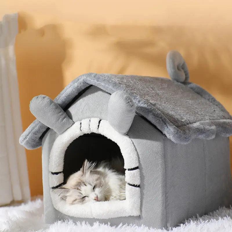 Gray plush cat house with soft white interior, featuring a cottage design and roof ears, perfect for cozy cat naps.